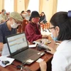 Cơ quan bưu điện chi trả lương hưu, trợ cấp bảo hiểm xã hội. (Ảnh: PV/Vietnam+)