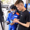 Nhân viên Petrolimex in hóa đơn mua xăng cho khách hàng. (Ảnh: Đức Duy/Vietnam+)