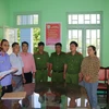 Cơ quan cảnh sát điều tra Công an tỉnh đọc lệnh bắt tạm giam bị can Trương Thị Hiệp (thứ 3 từ phải sang). (Ảnh: TTXVN phát)