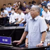 Bị cáo Lê Thanh Thản khai báo trước tòa. (Ảnh: Phạm Kiên/TTXVN)