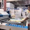 Đơn vị sản xuất giới thiệu công nghệ hiện đại trong ngành in ấn tại Triển lãm. (Ảnh: Mỹ Phương/TTXVN)