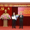 Thứ trưởng Bộ Kế hoạch và Đầu tư Nguyễn Duy Đông (trái) nhận quyết định của Ban Bí thư giữ chức Phó Bí thư Tỉnh ủy Vĩnh Phúc nhiệm kỳ 2020-2025. (Ảnh: Hoàng Hùng/TTXVN)
