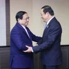 Thủ tướng Phạm Minh Chính và Thủ tướng Lào Sonexay Siphandone trong cuộc gặp tại Tokyo, Nhật Bản vào sáng 17/12/2023. (Ảnh: Dương Giang/TTXVN)