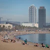 Người dân tắm mát trên bãi biển ở Barcelona, Tây Ban Nha. (Ảnh: AFP/TTXVN)