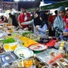 Người dân mua thực phẩm tại khu chợ ở Narathiwat, Thái Lan. (Ảnh: AFP/TTXVN)