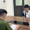 Đối tượng Quang tại cơ quan Công an. (Ảnh TTXVN phát)