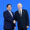 Tổng thống Liên bang Nga Vladimir Putin, Chủ tịch Nhóm BRICS năm 2024 đón Thủ tướng Phạm Minh Chính. (Ảnh: Dương Giang/TTXVN)