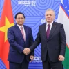 Thủ tướng Phạm Minh Chính gặp Tổng thống Uzbekistan Shavkat Mirziyoyev. (Ảnh: Dương Giang/TTXVN)