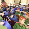 Các bị cáo tại phiên tòa ngày 26/3. (Ảnh: Thanh Vũ/TTXVN)