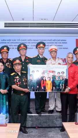 Đại diện Ban liên lạc truyền thống Tiểu đoàn 261 Giron tại Thành phố Hồ Chí Minh tặng ảnh kỷ niệm cho ông Mauricio Alejandro Martínez Duque, Tổng Lãnh sự Cộng hòa Cuba tại Thành phố Hồ Chí Minh. (Ảnh: Xuân Khu/TTXVN)
