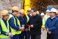 Thủ tướng Phạm Minh Chính chúc Tết công nhân thi công dự án tuyến đường cao tốc Đồng Đăng-Trà Lĩnh đoạn qua huyện Thạch An (Cao Bằng). (Ảnh: Dương Giang/TTXVN)