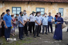 Hướng dẫn viên hướng dẫn du khách tham quan hệ thống phòng giam tại Nhà tù Côn Đảo. (Ảnh: Huỳnh Ngọc Sơn/TTXVN)
