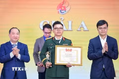 Đồng chí Bùi Quang Huy, Ủy viên dự khuyết Ban Chấp hành Trung ương Đảng, Bí thư thứ nhất Ban Chấp hành Trung ương Đoàn, Trưởng Ban Chỉ đạo 35 Trung ương Đoàn trao giải A cho tác giả. (Ảnh: Minh Đức/TTXVN)