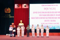 Thiếu tướng Nguyễn Thanh Tùng, Giám đốc Công an thành phố Hà Nội trao Giấy khen cho các đồng chí có nhiều đóng góp trong hoạt động của Ban liên lạc chiến trường B,C,K. (Ảnh: Phạm Kiên/TTXVN)