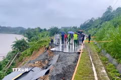 Theo ghi nhận tại hiện trường, toàn bộ phần mặt đường dài khoảng 30 mét đã bị đứt gãy, sạt trượt hoàn toàn xuống phía ta luy âm, giáp bờ sông Hồng. (Ảnh: TTXVN phát)