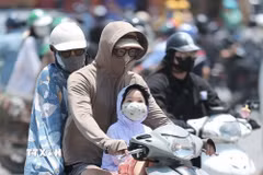 Người dân khi ra đường cần trang bị khăn, mũ, áo chống nắng. (Ảnh: Minh Quyết/TTXVN)