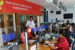 Cán bộ tiếp nhận hồ sơ giải quyết thủ tục cho người dân tại Trung tâm Phục vụ hành chính công phường Điện Biên Phủ (tỉnh Điện Biên) trong ngày đầu vận hành thử nghiệm. (Ảnh: Phan Quân/ TTXVN)