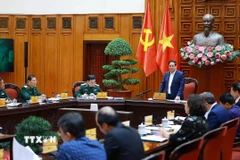 Thủ tướng Phạm Minh Chính làm việc với lãnh đạo Bộ Quốc phòng về phát triển công nghiệp quốc phòng. (Ảnh: Dương Giang/TTXVN)