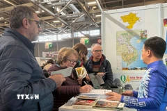 Du khách tìm hiểu các chương trình tham quan Việt Nam tại Triển lãm du lịch thế giới, được tổ chức từ ngày 12-15/3 tại thủ đô Paris. (Ảnh: Hữu Chiến/TTXVN)