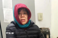 Đối tượng Nguyễn Thị Thu Nga khi bị Công an bắt giữ. (Ảnh: TTXVN phát)