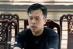 Đối tượng Hoàng Tứ Trạch (sinh năm 1985, trú tại thành phố Vinh, Nghệ An) tại cơ quan Công an. (Ảnh: TTXVN phát)
