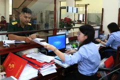 Để hỗ trợ Ngân hàng Nhà nước bình ổn thị trường dịp cận Tết, Bộ Tài chính đã xây dựng dự thảo Nghị quyết với nội dung trọng tâm là nới lỏng hạn mức gửi tiền. (Ảnh: Vietnam+)