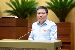 Thừa ủy quyền của Thủ tướng Chính phủ, Bộ trưởng Bộ Tài chính Nguyễn Văn Thắng đã trình bày Tờ trình về dự thảo Nghị quyết. (Ảnh: QH/Vietnam+)