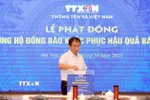 Phó Tổng Giám đốc TTXVN Nguyễn Tuấn Hùng ủng hộ đồng bào khắc phục hậu quả bão lũ. (Ảnh: Tuấn Anh/TTXVN)