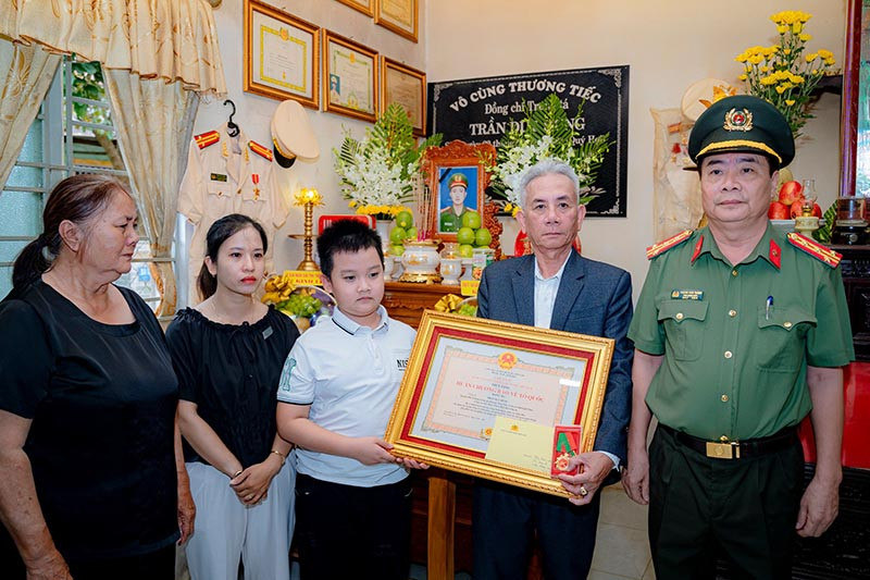 Đại tá Hoàng Văn Thành trao Huân chương Bảo vệ Tổ quốc hạng Ba cho thân nhân gia đình Trung tá Trần Duy Hùng, nguyên Phó trưởng Công an phường Thủy Vân, Công an TP Huế. (Ảnh: Cổng thông tin điện tử Tỉnh ủy Thừa Thiên-Huế)