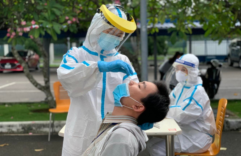 Các y bác sỹ Trung tâm kiểm soát bệnh tật Thành phố Hồ Chí Minh và Quận 7 thực hiện xét nghiệm sàng lọc COVID-19 ngẫu nhiên. (Ảnh: Thanh Vũ/TTXVN)