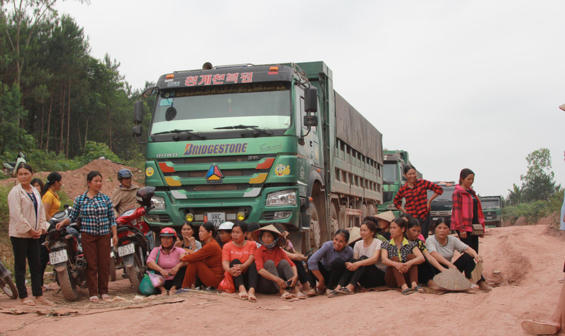Nhiều người trải chiếu, ngồi canh không cho xe qua lại công trình. (Ảnh: Quang Duy/TTXVN)