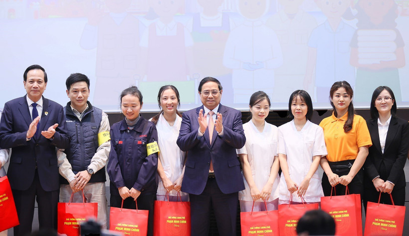 Thủ tướng Phạm Minh Chính tặng quà cho đại diện thực tập sinh và người lao động đang làm việc tại Nhật Bản. (Ảnh: Dương Giang/TTXVN)