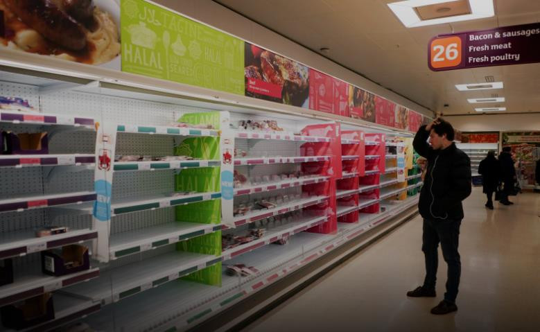 Một người đàn ông đứng cạnh các kệ thị trống không trong một siêu thị tại Anh ngày 15/3/2020. (Nguồn: Reuters)