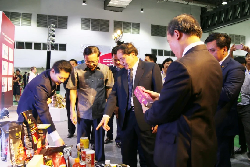 Lãnh đạo Bộ Công thương hai nước và các đại biểu tham quan một số sản phẩm tại hội chợ. (Ảnh: Xuân Tú/TTXVN)