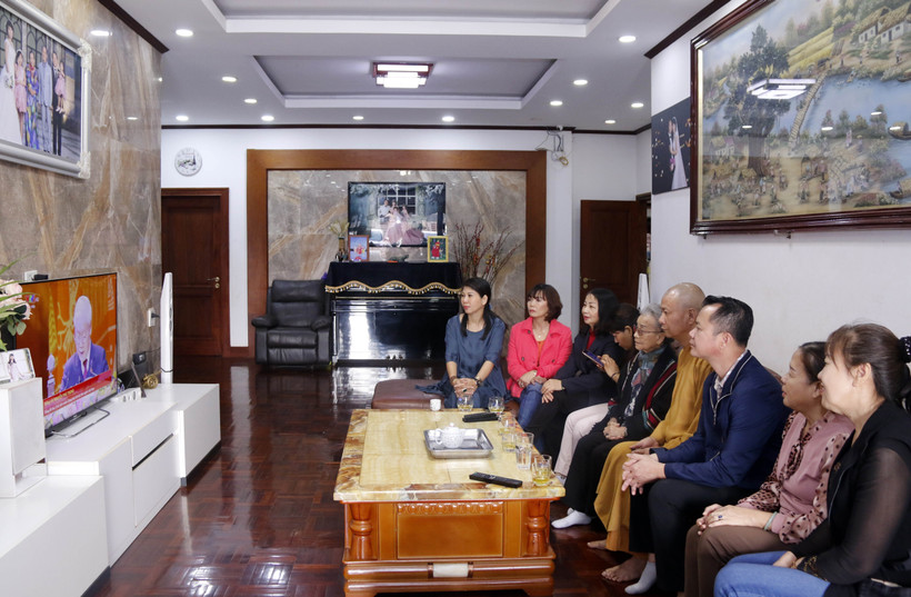 Người Việt tại Lào tập trung theo dõi lễ khai mạc Đại hội Đảng XIII. (Ảnh: Phạm Kiên/TTXVN)