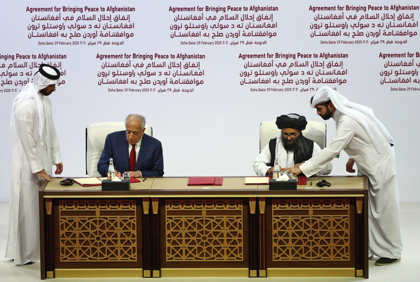 Đại diện đặc biệt của Mỹ về hòa giải tại Afghanistan Zalmay Khalilzad (thứ 2, trái) và người đồng sáng lập Taliban Mullah Abdul Ghani Baradar (thứ 2, phải) tại lễ ký thỏa thuận hòa bình ở Doha, Qatar ngày 29/2/2020. (Ảnh: AFP/TTXVN)