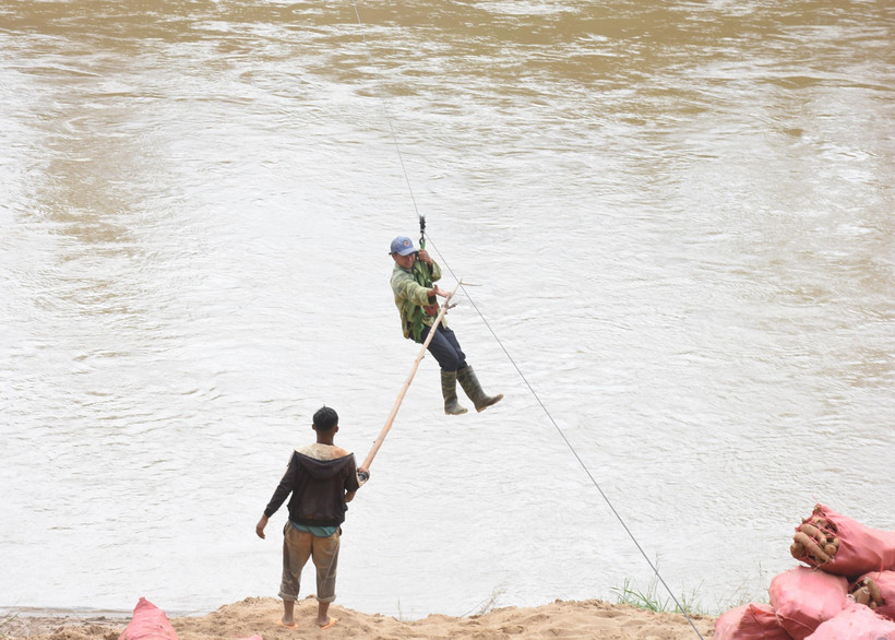 Người dân liều mình đu dây qua sông Pô Kô. (Ảnh: Khoa Chương/TTXVN)