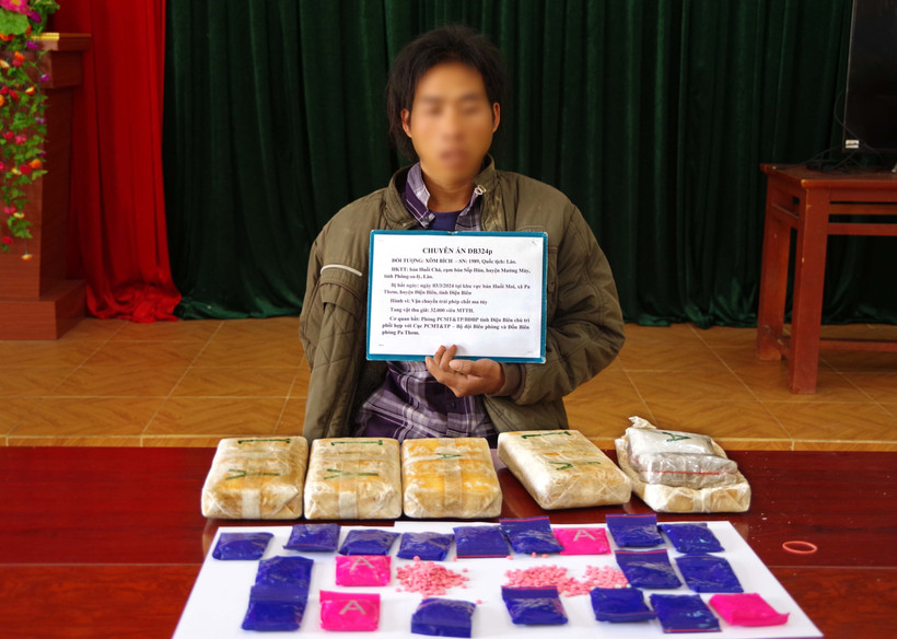 Đối tượng Xôm Bích cùng tang vật vụ án. (Ảnh: TTXVN phát)