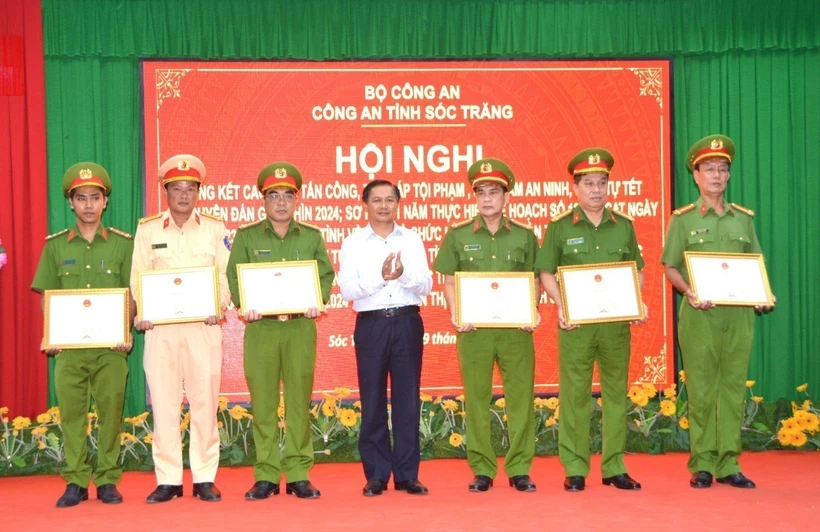 Chủ tịch UBND tỉnh Sóc Trăng Trần Văn Lâu trao Bằng khen của UBND tỉnh cho 1 tập thể và 5 cá nhân có thành tích xuất sắc trong vụ việc giải cứu con tin. (Ảnh: TTXVN phát)