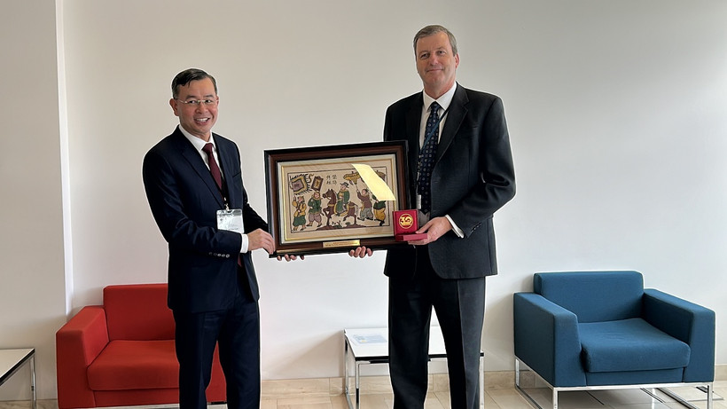 Tổng Kiểm toán Nhà nước Ngô Văn Tuấn tặng quà lưu niệm cho Tổng kiểm toán và kiểm soát Vương quốc Anh Gareth Davies. (Ảnh: Phong Hà/TTXVN)