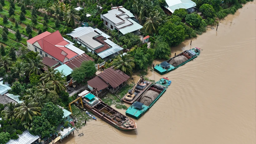 Một điểm tập kết, trung chuyển cát ở khu vực giáp ranh giữa tỉnh Tiền Giang và tỉnh Vĩnh Long. (Ảnh: Hoài Nam/Vietnam+)