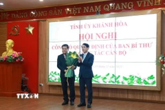 Bí thư Tỉnh ủy Khánh Hòa Nghiêm Xuân Thành tặng hoa chúc mừng tân Phó Bí thư Tỉnh ủy Khánh Hòa Trần Phong. (Ảnh: Xuân Triệu/TTXVN)