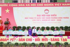 Bà Trương Thị Bích Hạnh, Phó Chủ tịch Thường trực Ủy ban MTTQ Việt Nam Thành phố Hồ Chí Minh và ông Trương Quốc Trung, Bí thư Đảng ủy phường Bình Trưng trao tặng kinh phí hỗ trợ hộ gia đình có hoàn cảnh khó khăn trên địa bàn phường. (Ảnh: Xuân Khu/TTXVN)