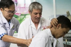 Bác sỹ người Pháp Mezard Marc (giữa) luôn nhiệt tình hướng dẫn các học viên nước ngoài nghiên cứu và thực hành điều trị theo phương pháp y học dân tộc Việt Nam. (Ảnh: Thông Hải/ Báo Ảnh Việt Nam)