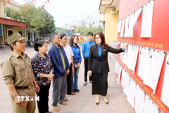 Đoàn Thanh niên phường Hồng Châu (Hưng Yên) thông tin về người ứng cử cho cử tri tại khu vực bỏ phiếu. (Ảnh: Thu Hoài/TTXVN)