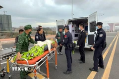 Xe cứu thương đưa anh BI MINGXIAN (sinh năm 1969), bị u não, xuất cảnh sang Trung Quốc để cứu chữa. (Ảnh: TTXVN phát)