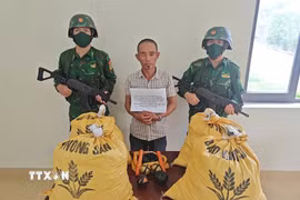 Đối tượng Nguyễn Duy Khánh cùng tang vật bị bắt giữ. (Ảnh: TTXVN phát)
