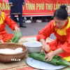 Các nghệ nhân thực hiện gói bánh chưng tại Hội thi. (Ảnh: Thu Hương/TTXVN)