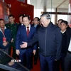 Tổng Bí thư Tô Lâm và các đại biểu tham quan không gian trưng bày ảnh về Ban Chấp hành Đảng bộ tỉnh Cao Bằng. (Ảnh: Thống Nhất/TTXVN)