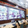 Cán bộ, chiến sỹ Cảnh sát gioa thông giám sát giao thông 24/24 bằng camera AI tại trung tâm thông tin chỉ huy thuộc Cục Cảnh sát giao thông, Bộ Công an. (Ảnh: Phạm Kiên/TTXVN)
